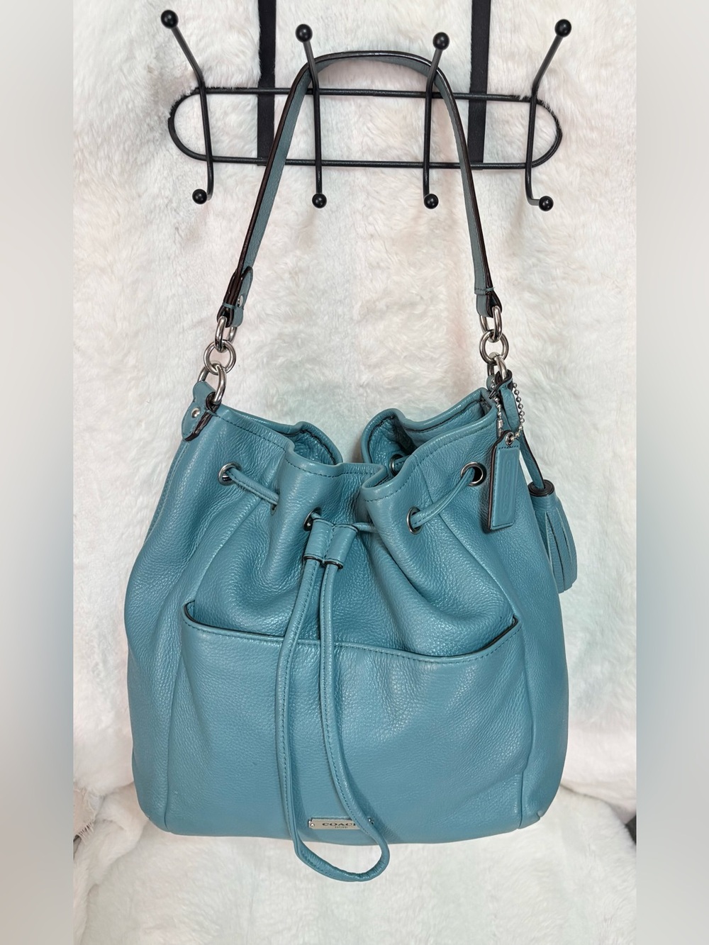 teal blue Coach Avery pebbled leather bucket drawstring shoulder bag.